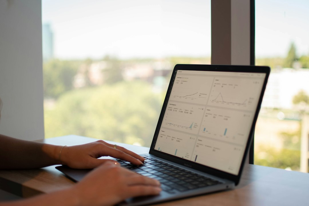 Accreditation coordinator reviewing AI-generated evidence analysis on a laptop