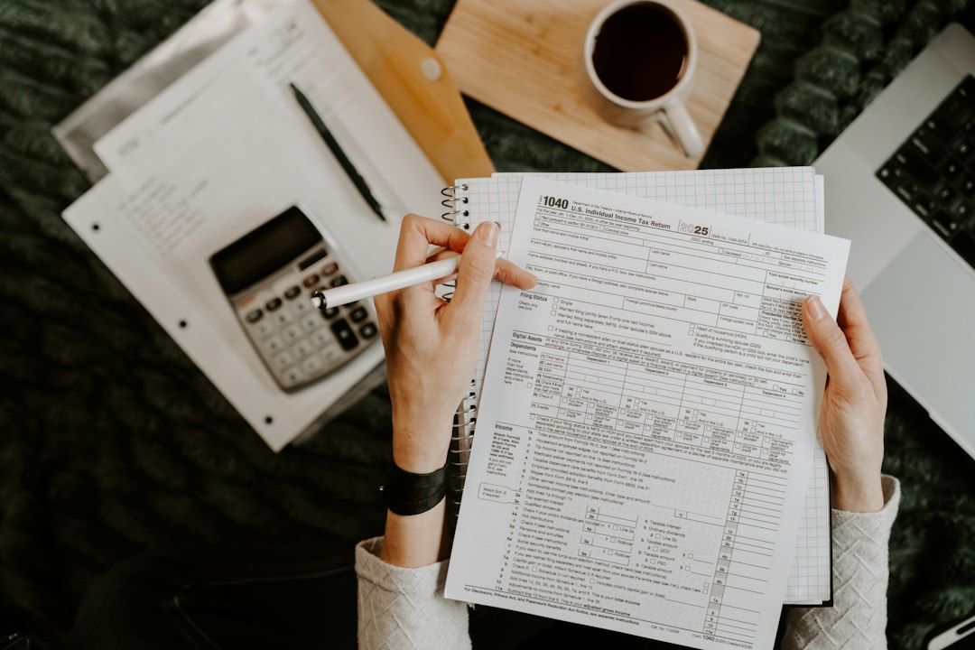 A coordinator reviewing a stack of standards documents with a calculator and pen