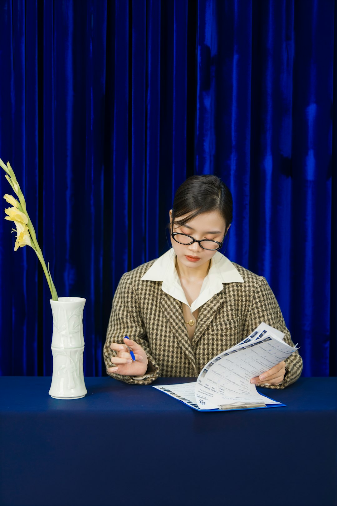 An accreditation coordinator reviews the CoA directory documents at her desk