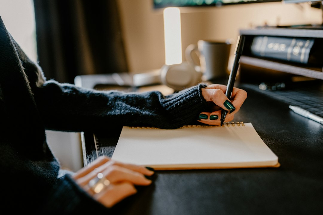 A coordinator writing the committee minutes in a notebook