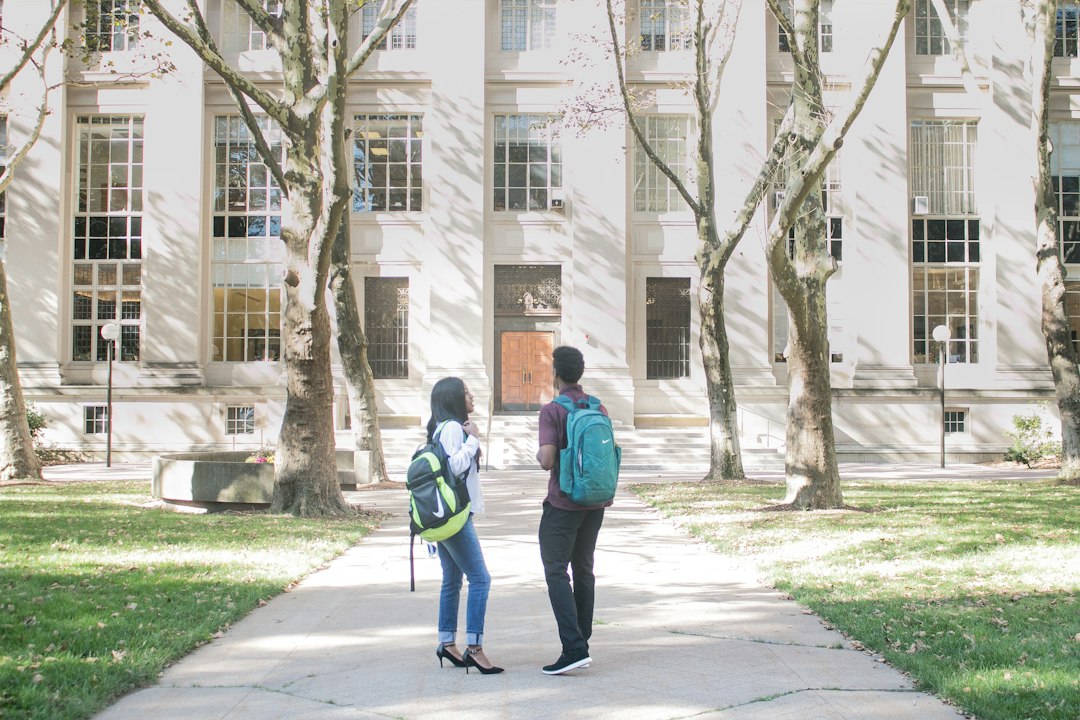 Two students standing in front of a university building