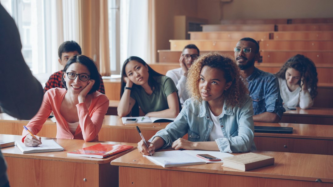University students taking notes in a lecture hall